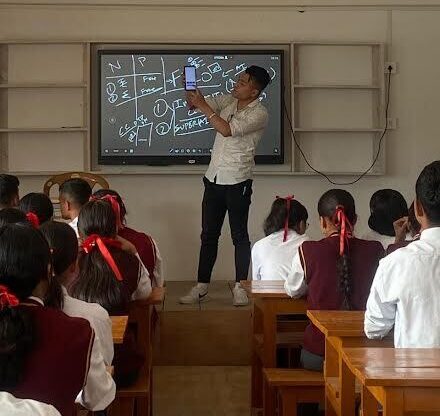 Teacher explaining concepts to students.